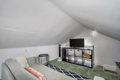 a living room with a couch and a tv at Cozy Cottage in the Heart of Hyde Park home in Cincinnati