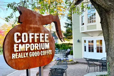 a sign for a coffee emporium in front of a house at Cozy Cottage in the Heart of Hyde Park home in Cincinnati