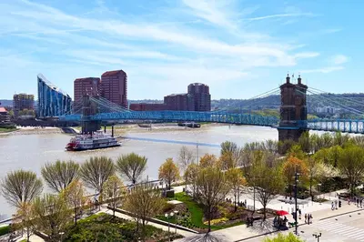 a blue bridge over a river in a city at Cozy Cottage in the Heart of Hyde Park home in Cincinnati