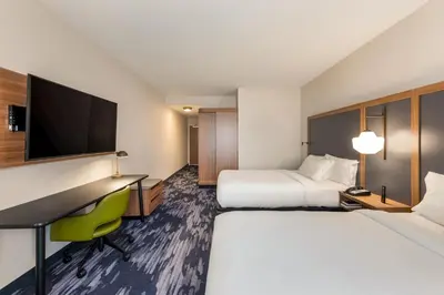 a hotel room with two beds and a desk and a tv at Fairfield by Marriott Inn & Suites Columbus Canal Winchester in Canal Winchester