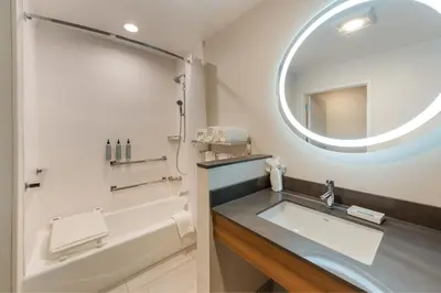 a bathroom with a tub and a sink and a mirror at Fairfield by Marriott Inn & Suites Columbus Canal Winchester in Canal Winchester