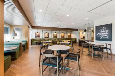 a restaurant with tables and chairs and a bar at Fairfield by Marriott Inn & Suites Columbus Canal Winchester in Canal Winchester