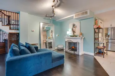 a living room with a blue couch and a fireplace at Family Home Swim Spa, Patios, Grill and Fire Pit in Delaware