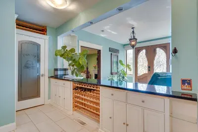 a kitchen with blue walls and a wine cellar at Family Home Swim Spa, Patios, Grill and Fire Pit in Delaware
