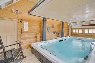 a large hot tub in a room with wooden walls at Family Home Swim Spa, Patios, Grill and Fire Pit in Delaware