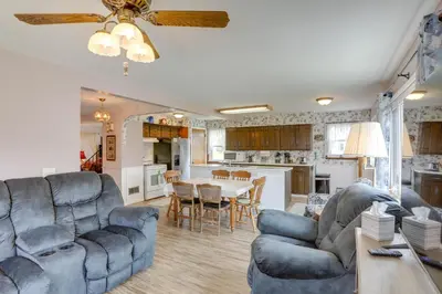 a living room with a blue couch and a table at Home with Screened-In Porch Less Than 1 Mi to Lake Erie in Port Clinton