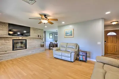 a living room with a ceiling fan and a fireplace at Dayton Home with Patio and Fire Pit about 6 Mi Dtwn! in Dayton