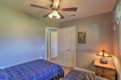 a bedroom with a blue bed and a ceiling fan at Dayton Home with Patio and Fire Pit about 6 Mi Dtwn! in Dayton