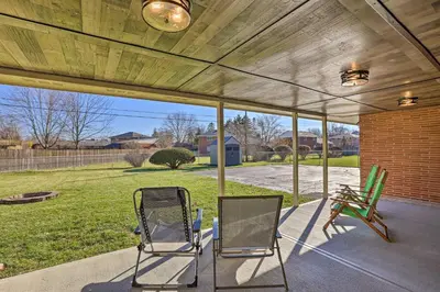 two chairs sitting on a patio with awning at Dayton Home with Patio and Fire Pit about 6 Mi Dtwn! in Dayton