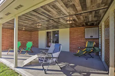 a porch with four chairs and a wooden ceiling at Dayton Home with Patio and Fire Pit about 6 Mi Dtwn! in Dayton