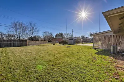 a yard with a fence and the sun in the sky at Dayton Home with Patio and Fire Pit about 6 Mi Dtwn! in Dayton