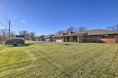 a yard of a house with a large lawn at Dayton Home with Patio and Fire Pit about 6 Mi Dtwn! in Dayton