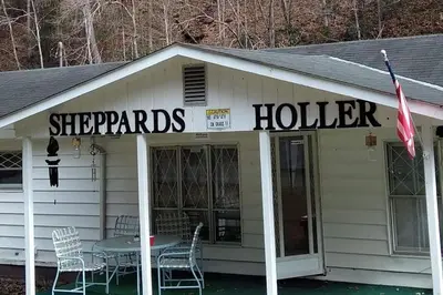 a building with a table and chairs in front of it at Sheppard's Holler in Parsley