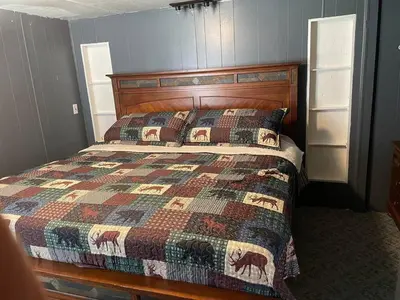 a bedroom with a bed with a quilt on it at Sheppard's Holler in Parsley