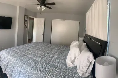 a bedroom with a bed with pillows and a ceiling fan at Spacious Four Bedroom Attached Home in Springboro- Unit 1 in Springboro