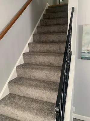a staircase in a house with grey carpet at Spacious Four Bedroom Attached Home in Springboro- Unit 1 in Springboro