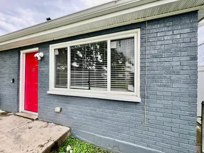 a house with a window with a red door at A Great Place for Workers on Whitaker-Unit B in Hamilton