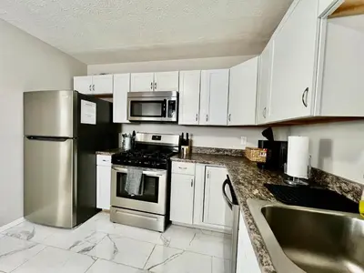 a kitchen with white cabinets and stainless steel appliances at A Great Place for Workers on Whitaker-Unit B in Hamilton