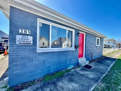 a house with a red door and a sign on it at A Great Place for Workers on Whitaker-Unit B in Hamilton