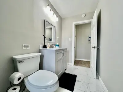a white bathroom with a toilet and a mirror at A Great Place for Workers on Whitaker-Unit B in Hamilton