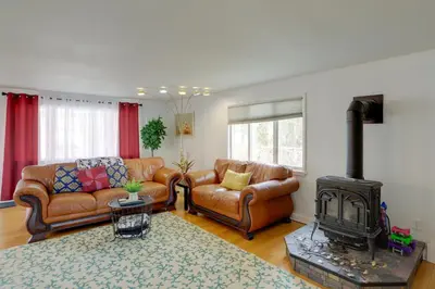 a living room with leather furniture and a fireplace at Spacious Lakefront House with Backyard Fire Pit in Monroe