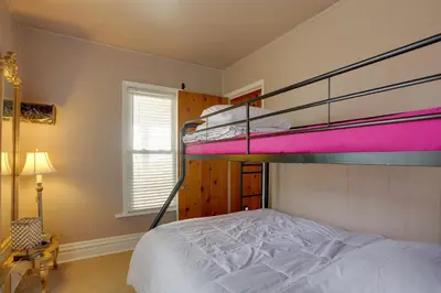 a bedroom with two bunk beds and a lamp at Spacious Lakefront House with Backyard Fire Pit in Monroe