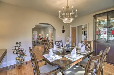 a dining room with a table and chairs and a chandelier at Half-Mi to Dawkins Rail Trail Family Home with Yard in Paintsville