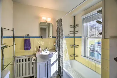 a bathroom with a sink and a tub and a shower at Half-Mi to Dawkins Rail Trail Family Home with Yard in Paintsville
