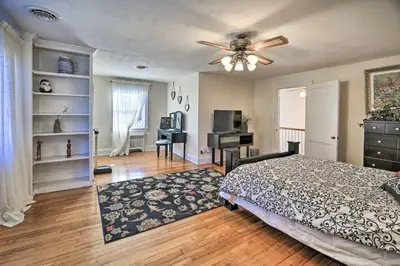 a bedroom with a bed and a ceiling fan at Half-Mi to Dawkins Rail Trail Family Home with Yard in Paintsville