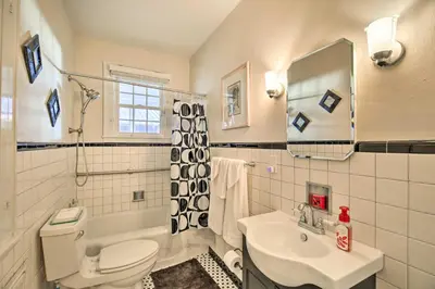 a bathroom with a white toilet and a sink at Half-Mi to Dawkins Rail Trail Family Home with Yard in Paintsville