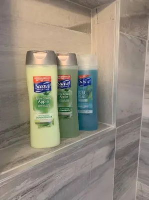 three bottles of sunscreen sitting on a shelf at 6 BR Home Just Minutes From Downtown Cincinnati in Cincinnati