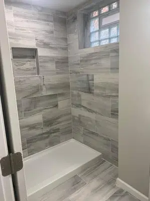 a bathroom with a shower with a white tub at 6 BR Home Just Minutes From Downtown Cincinnati in Cincinnati