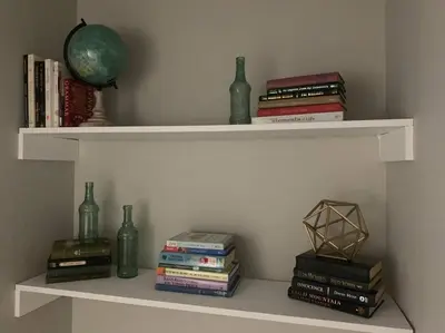 a shelf with books and vases and books at 6 BR Home Just Minutes From Downtown Cincinnati in Cincinnati