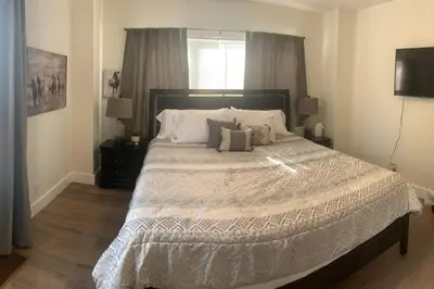 a bedroom with a large bed with white sheets and pillows at Remodeled Farm House with Plenty of Charm in Monroe