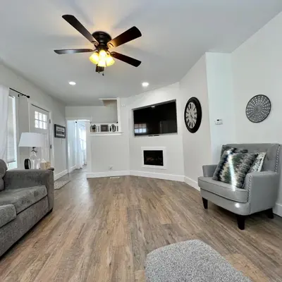 a living room with a couch and a ceiling fan at Remodeled Farm House with Plenty of Charm in Monroe