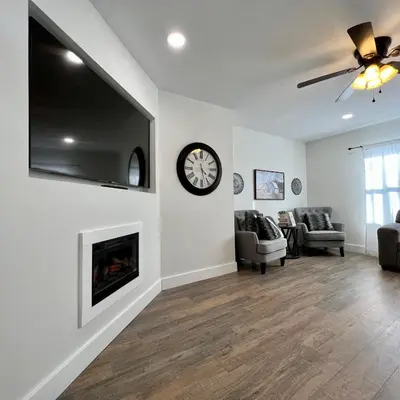 a living room with a fireplace and a clock on the wall at Remodeled Farm House with Plenty of Charm in Monroe