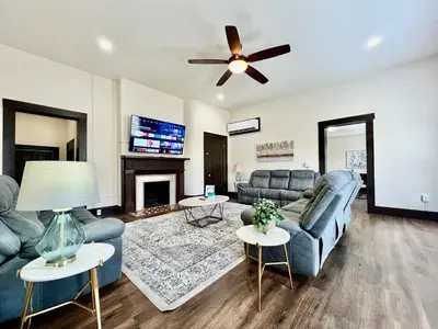 a living room with couches and a fireplace at Newly Renovated Historic mansion ☆ 8 Bedrooms in Hamilton
