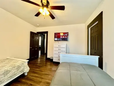 a bedroom with a bed and a ceiling fan at Newly Renovated Historic mansion ☆ 8 Bedrooms in Hamilton