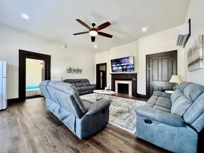 a living room with two couches and a ceiling fan at Newly Renovated Historic mansion ☆ 8 Bedrooms in Hamilton