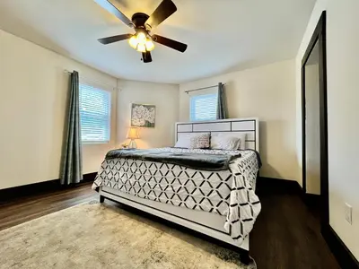 a bedroom with a bed and a ceiling fan at Newly Renovated Historic mansion ☆ 8 Bedrooms in Hamilton