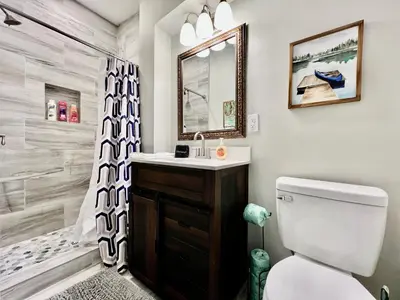 a bathroom with a toilet and a sink and a shower at Charming 4BR Home in Liberty Township w Large Deck in Maustown