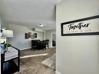 a living room with a table and a sign on a wall at Charming 4BR Home in Liberty Township w Large Deck in Maustown