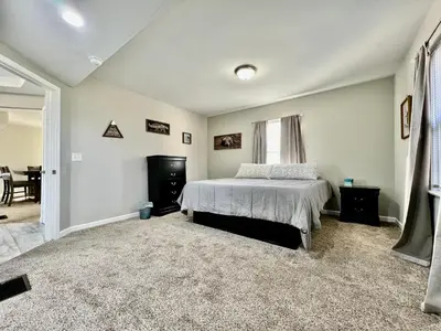 a bedroom with a bed and a dining room at Charming 4BR Home in Liberty Township w Large Deck in Maustown