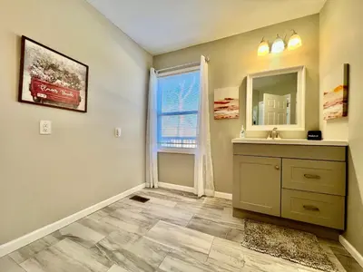 a bathroom with a sink and a mirror at Charming 4BR Home in Liberty Township w Large Deck in Maustown