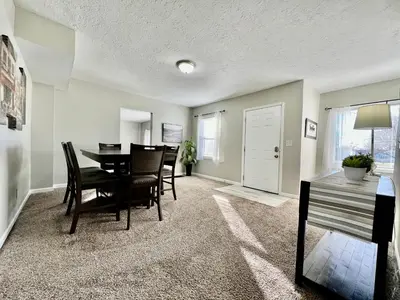 a dining room and living room with a table and chairs at Charming 4BR Home in Liberty Township w Large Deck in Maustown