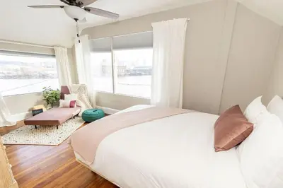 a bedroom with a large bed and a window at Cozy Riverfront Bungalow with Stunning Views in Covington