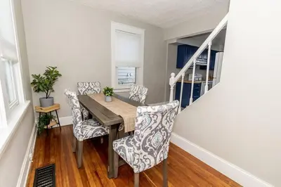 a dining room with a wooden table and chairs at Cozy Riverfront Bungalow with Stunning Views in Covington