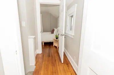 a hallway leading to a bedroom with a bed at Cozy Riverfront Bungalow with Stunning Views in Covington