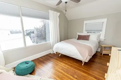 a bedroom with a bed and a large window at Cozy Riverfront Bungalow with Stunning Views in Covington