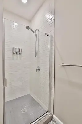 a shower with a glass door in a bathroom at *New* XquisiteMidCenturyM0d~ Condo *OTR* w/Parking in Cincinnati